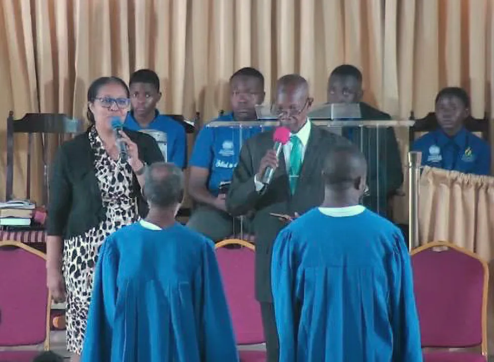 Baptismal candidates in robes at the front of the church