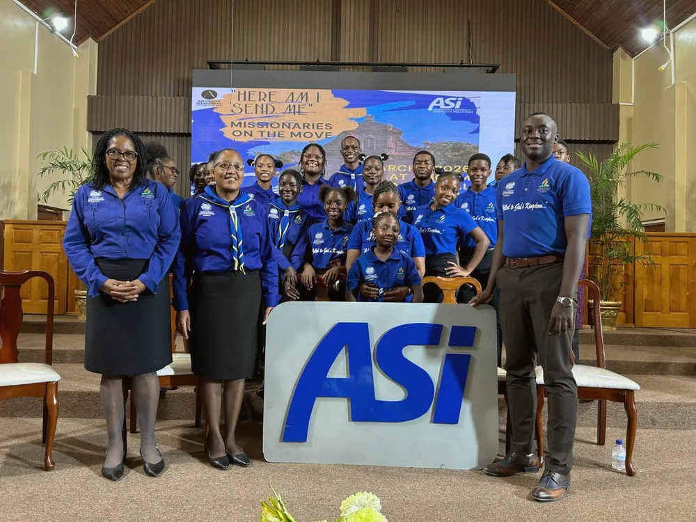 Penwood ASI missionaries gathered behind the ASI sign