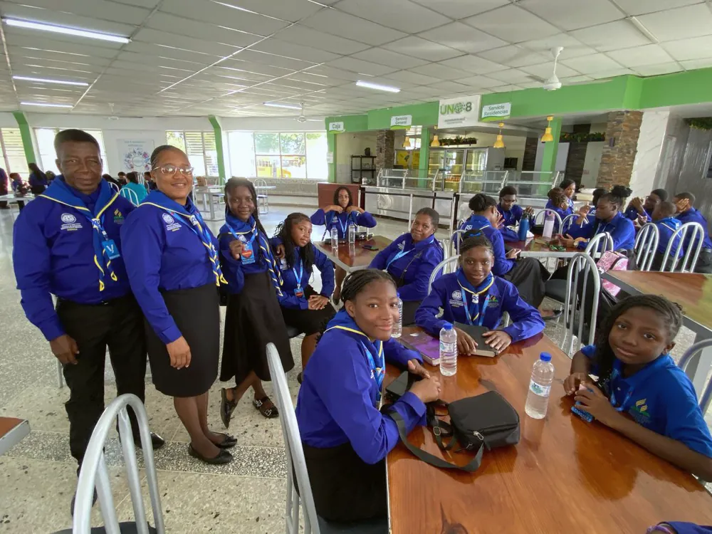 Missionaries gathered around tables in the dining hall