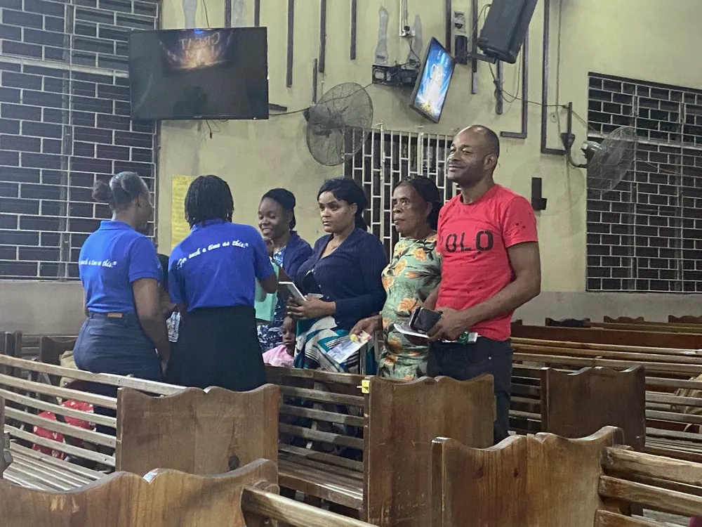 Members speaking with visitors in the church