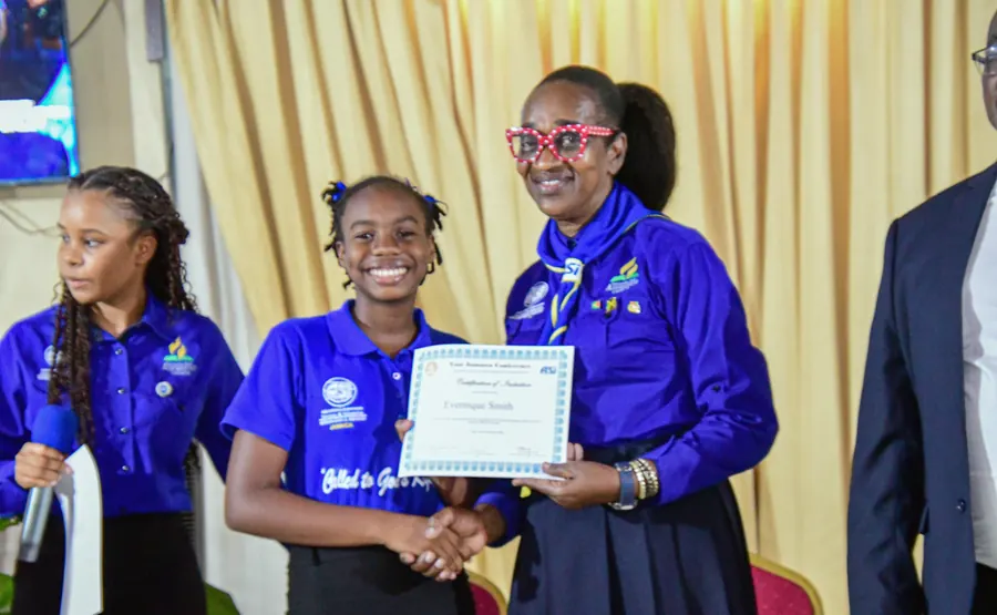 A newly inducted missionary receives her certificate