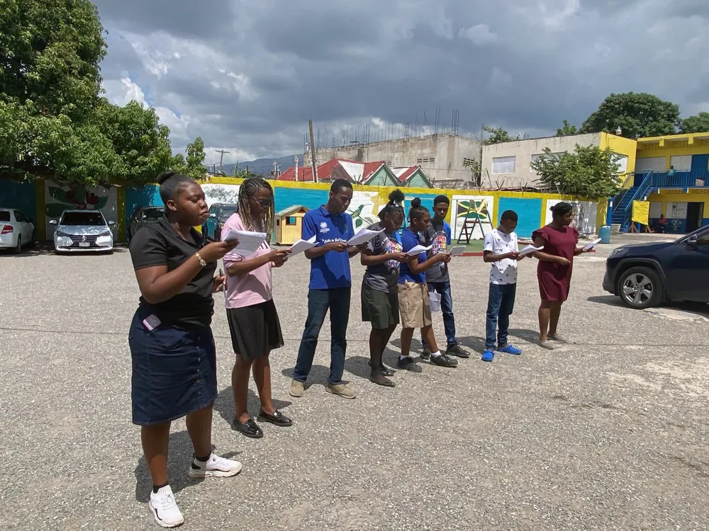 Young people reading together outdoors