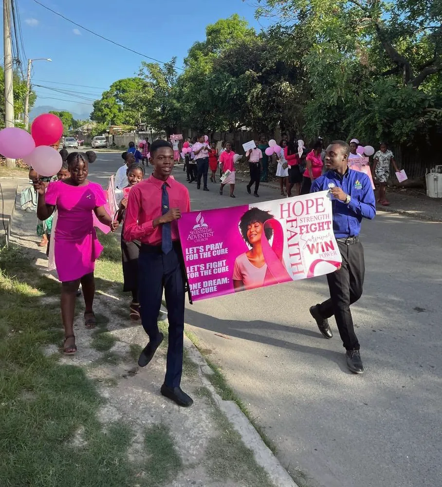 Members marching down the street with the banner