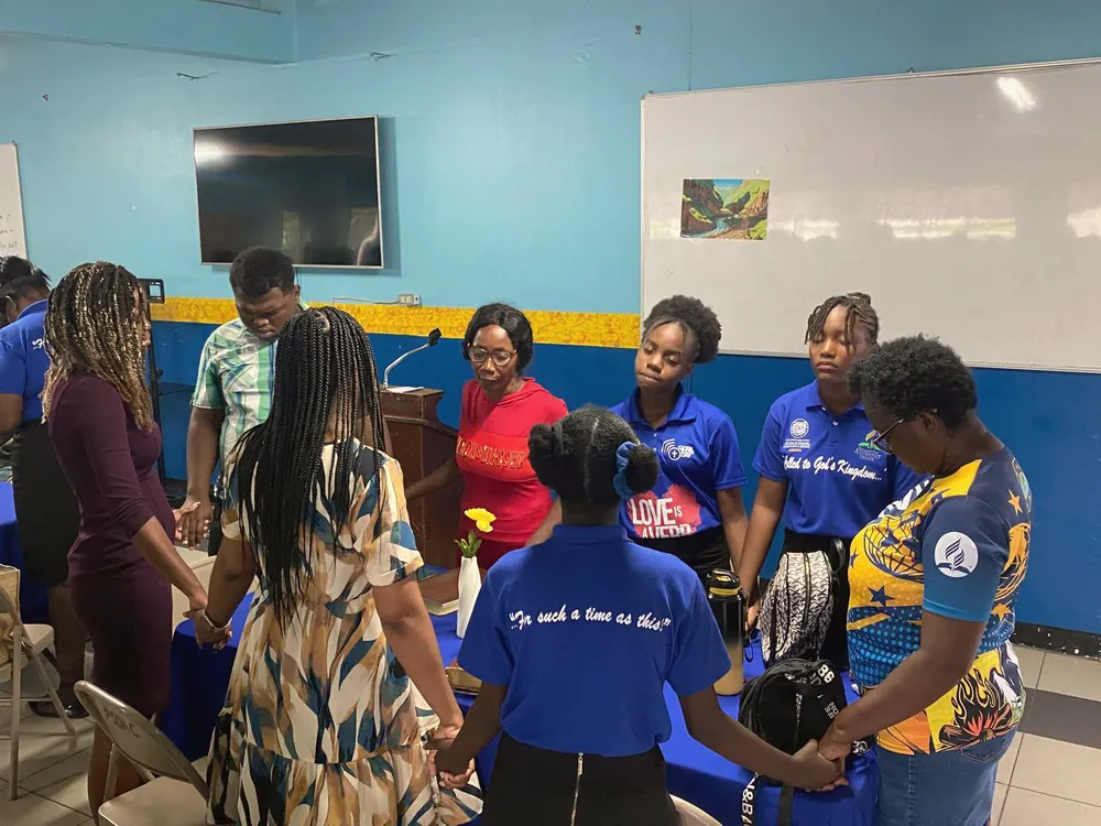 Members joined hand in hand in a prayer circle