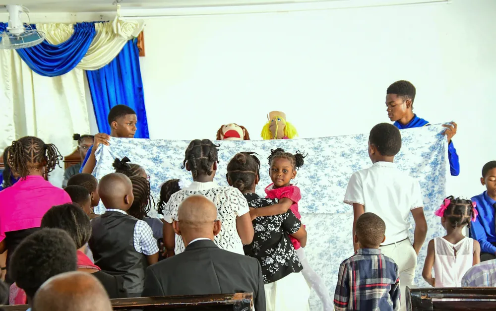 Young people presenting a puppet show to the children