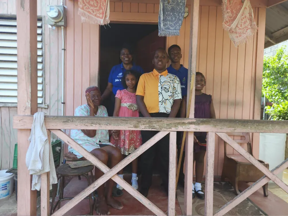 Missionaries visiting church members on a porch