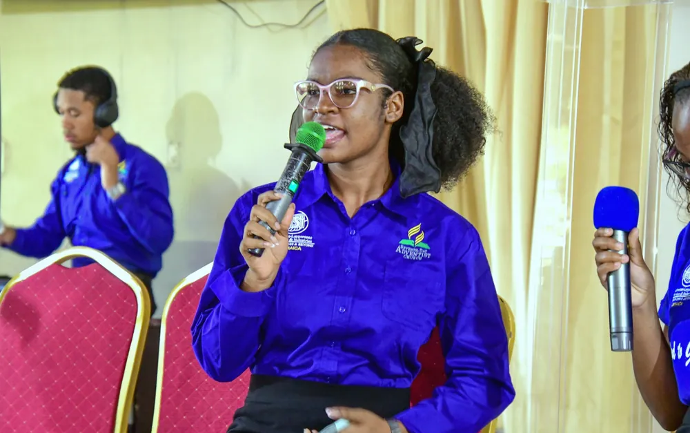 A young missionary speaking into a microphone